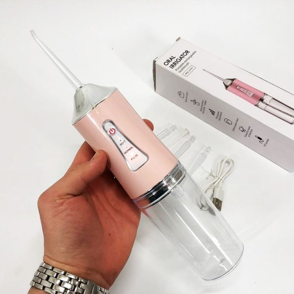 Ирригатор для чистки зубов и полости рта oral irrigator с аккумулятором и сменными насадками. цвет: розовый 00014508 фото