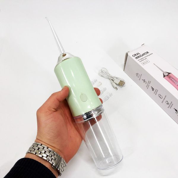 Іригатор для чищення зубів та порожнини рота oral irrigator з акумулятором та змінними насадками. колір: зелений 00014509 фото